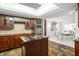 Open kitchen features granite island and view to dining area at 8984 Houston Pl # 103, Orlando, FL 32819