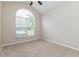 Bedroom with arched window and ceiling fan at 1111 Partin Dr, Kissimmee, FL 34744