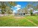 House's rear view, showcasing a spacious backyard at 1515 Indiana Ave, Saint Cloud, FL 34769