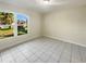 Large spare bedroom with tile flooring and a window at 706 Tournament Ln, Kissimmee, FL 34759