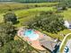 Aerial view of community pool with lounge chairs and a covered pavilion at 1180 Lone Palm Way, Saint Cloud, FL 34771