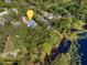 Aerial view of house near lake and lush vegetation at 143 Debary Dr, Debary, FL 32713