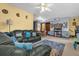 Cozy living room featuring a leather sofa, area rug, and ceiling fan at 1921 Canton St, Orlando, FL 32803