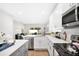Modern kitchen with white cabinets, stainless steel appliances, and a large island at 1780 Grand Oak Dr, Apopka, FL 32703