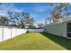 Spacious backyard with a grassy lawn and white fence at 1780 Grand Oak Dr, Apopka, FL 32703