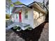 Updated home exterior with pink door and gray railing at 709 N Lincoln Ave, Lakeland, FL 33815