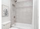 Bathroom with a shower/tub combo, tile surround and a decorative framed print at 322 Westchester Dr, Altamonte Springs, FL 32701