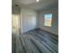 Well-lit bedroom with vinyl flooring and access to hallway at 6208 Sw 129, Ocala, FL 34473