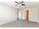 Spacious bedroom with ceiling fan, neutral color walls, and plush carpeting at 2036 Van Buren Loop, Auburndale, FL 33823