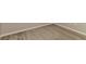 Close-up view of a carpeted bedroom corner with white baseboards at 2036 Van Buren Loop, Auburndale, FL 33823