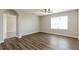 Spacious living room with dark wood flooring and a ceiling fan at 2036 Van Buren Loop, Auburndale, FL 33823