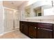 Elegant bathroom with double vanity, granite countertops and a large shower at 2036 Van Buren Loop, Auburndale, FL 33823
