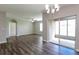 Spacious living room featuring hardwood floors, high ceilings, and access to the patio at 2036 Van Buren Loop, Auburndale, FL 33823
