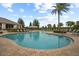 Community pool with lounge chairs and landscaping at 9747 Lost Creek Dr, Winter Garden, FL 34787