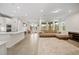 Open living room and kitchen with large windows and neutral color palette at 9747 Lost Creek Dr, Winter Garden, FL 34787