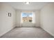 Empty bedroom with neutral wall paint and carpet, featuring two large windows at 9747 Lost Creek Dr, Winter Garden, FL 34787