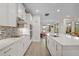 Clean kitchen features white cabinets, quartz countertops, and a stylish backsplash at 9747 Lost Creek Dr, Winter Garden, FL 34787