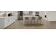 Modern kitchen island with seating, white cabinets, and stylish light fixtures at 9747 Lost Creek Dr, Winter Garden, FL 34787