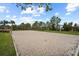 Sand volleyball court with net and natural scenery at 9747 Lost Creek Dr, Winter Garden, FL 34787