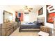 Bright bedroom with a large bed, dresser, and ceiling fan at 796 Humphrey Cir, Deltona, FL 32738