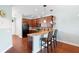 Modern kitchen with dark wood cabinets, stainless steel appliances and breakfast bar at 22011 Belgian Ct, Mount Dora, FL 32757