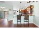 Open kitchen features a breakfast bar, dark wood cabinets, and stainless steel appliances at 22011 Belgian Ct, Mount Dora, FL 32757