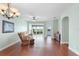 Spacious living room with hardwood floors, ceiling fan, and views to backyard at 22011 Belgian Ct, Mount Dora, FL 32757