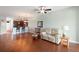 Open living room with hardwood floors, kitchen view and access to patio at 22011 Belgian Ct, Mount Dora, FL 32757