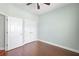 Spacious bedroom with wood-look tile floors and double door closet at 22011 Belgian Ct, Mount Dora, FL 32757