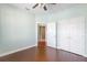 Bedroom with wood-look floors, double door closet and access to bathroom at 22011 Belgian Ct, Mount Dora, FL 32757