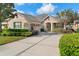 Attractive home exterior with landscaping and driveway at 22011 Belgian Ct, Mount Dora, FL 32757