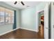 Bright office with wood-look tile floor, window with blinds, and view of backyard at 22011 Belgian Ct, Mount Dora, FL 32757
