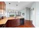 Kitchen boasts granite counters and dark wood cabinets at 22011 Belgian Ct, Mount Dora, FL 32757