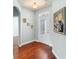 Bright and airy entryway with hardwood floors and a lovely glass front door at 22011 Belgian Ct, Mount Dora, FL 32757