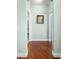 Light and airy hallway with wood flooring and access to multiple rooms at 22011 Belgian Ct, Mount Dora, FL 32757