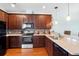 Modern kitchen featuring dark wood cabinetry and granite countertops at 22011 Belgian Ct, Mount Dora, FL 32757