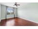 Spacious bedroom with hardwood floors and large window at 22011 Belgian Ct, Mount Dora, FL 32757