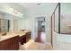 Main bathroom with double vanity, walk in shower, and bedroom access at 22011 Belgian Ct, Mount Dora, FL 32757