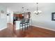 Eat-in kitchen boasts dark wood cabinets, stainless steel appliances & hardwood floors at 22011 Belgian Ct, Mount Dora, FL 32757