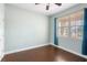 Bright bedroom with wood-look tile floors and window with blinds at 22011 Belgian Ct, Mount Dora, FL 32757