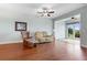 Relaxing living room with hardwood floors, a comfy couch, and access to a sunroom at 22011 Belgian Ct, Mount Dora, FL 32757