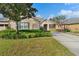 Well-maintained home exterior with landscaping and driveway at 22011 Belgian Ct, Mount Dora, FL 32757