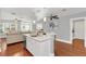 Modern white kitchen with a breakfast bar and hardwood floors at 1621 E Amelia St, Orlando, FL 32803