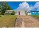 Gray house exterior with red door and nicely landscaped lawn at 3121 Bon Air Dr, Orlando, FL 32818