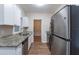 Modern kitchen with white cabinets, granite counters, and stainless steel appliances at 3121 Bon Air Dr, Orlando, FL 32818