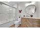Clean bathroom with tub, shower, vanity, and decorative accents at 4562 Baleno Ln, Kissimmee, FL 34746