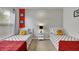 Twin bedroom with Mickey Mouse themed wallpaper and red accents at 4562 Baleno Ln, Kissimmee, FL 34746