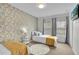 Bright bedroom with twin beds, geometric accent wall, and window coverings at 4562 Baleno Ln, Kissimmee, FL 34746