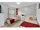 Charming bedroom with two twin beds, accent wall, and window coverings at 4562 Baleno Ln, Kissimmee, FL 34746