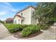 Two-story house with light-colored exterior, landscaping, and sidewalk at 4562 Baleno Ln, Kissimmee, FL 34746